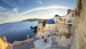 Golden light reflecting off the whitewashed buildings of Santorini