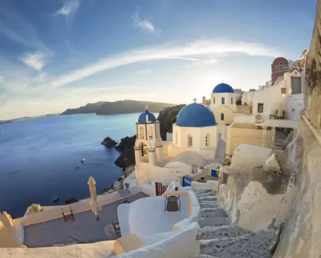 Golden light reflecting off the whitewashed buildings of Santorini