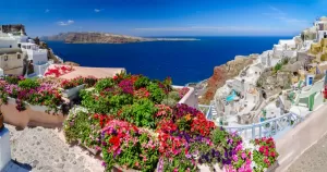 Colorful flowers and brilliant blue skies complement beautiful Greek islands