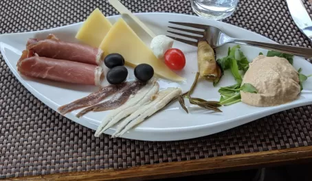 Typical Croatian foods, prosciutto, olives, salted fish and cheeses