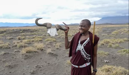 Our Maasai guide, Lemra, holding up the horns of a wildebeest.