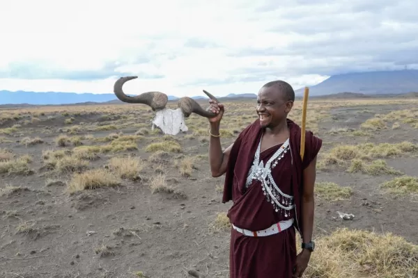 Our Maasai guide, Lemra, holding up the horns of a wildebeest.