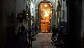 Alleyway door leading to a 3 table restaurant