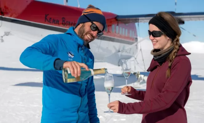 Enjoying champagne at Three Glaciers Retreat. Courtesy Christopher Michel, Antarctic Logistics & Expeditions