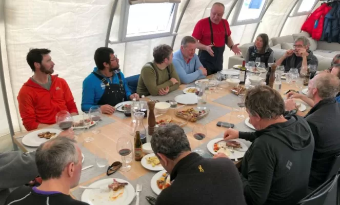 Enjoying a meal at Three Glaciers Retreat. Courtesy Christopher Michel, Antarctic Logistics & Expeditions