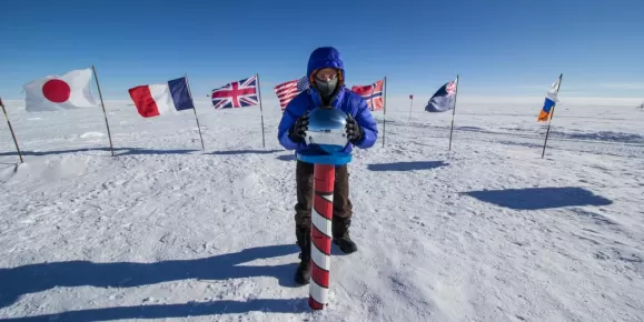 Posing at the Ceremonial South Pole. Courtesy Adam Ungar, Antarctic Logistics & Expeditions