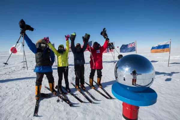 Skiers celebrate reaching the Ceremonial South Pole. Courtesy Eric Larsen, Antarctic Logistics & Expeditions