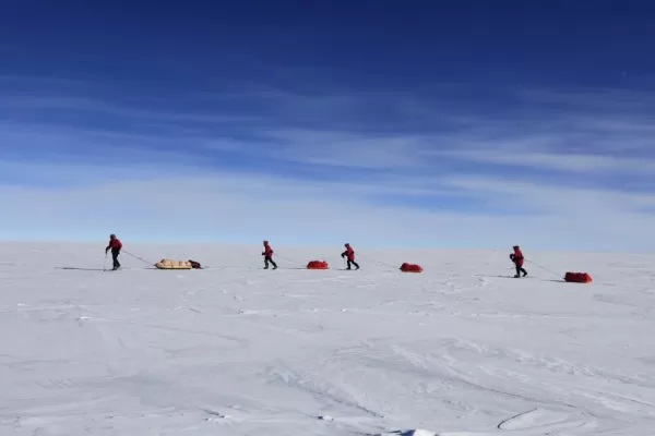 Skiers make their way to the South Pole pulling their sleds. Courtesy John Beatty, Antarctic Logistics & Expeditions