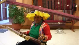 A weaver at the textile center in Cusco