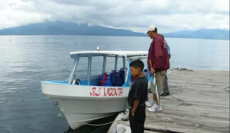 The boat, pilot, and Hugo on Lake Atitlan