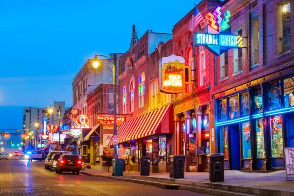 Photo of colorful cafe bars at the iconic Beale Street music and entertainment district of downtown Memphis, Tennessee, USA, illuminated at night