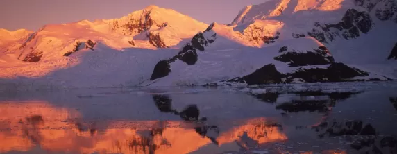 The sun sets over polar mountains
