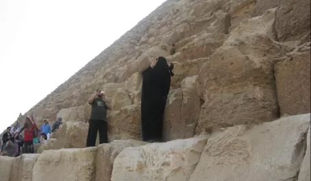 Look closely- He's taking her picture in a full burqa