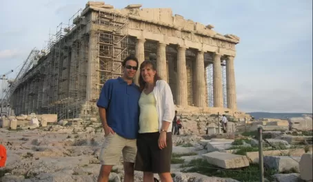 Standing in front of the ruins of Greece.
