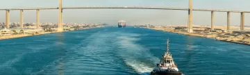 Ship passing through Suez Canal, in the background - the Suez Canal Bridge, also known as Al Salam Bridge