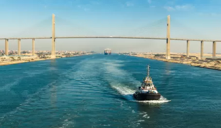 Ship passing through Suez Canal, in the background - the Suez Canal Bridge, also known as Al Salam Bridge