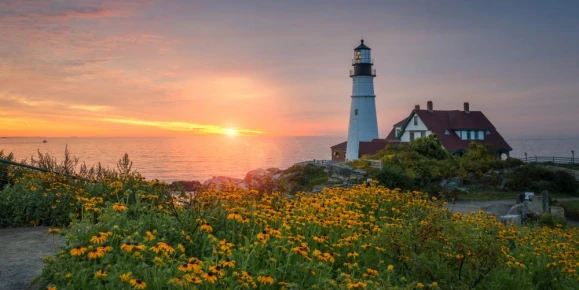 Colorful sunrise at Portland Head Lighthouse in Maine