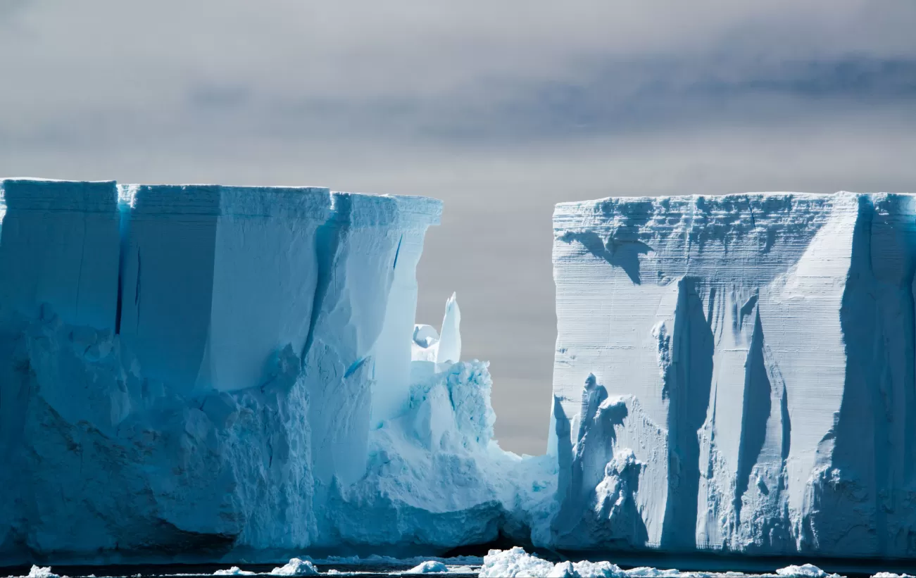 Raking light on a blue white floating tabular iceberg in the Weddell Sea