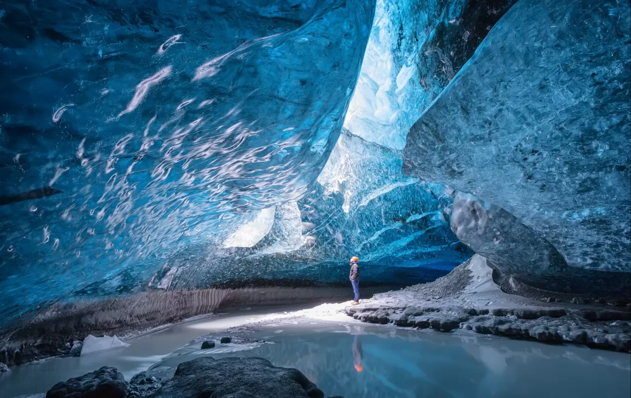 A man standing in Vatnajokull ice cave.