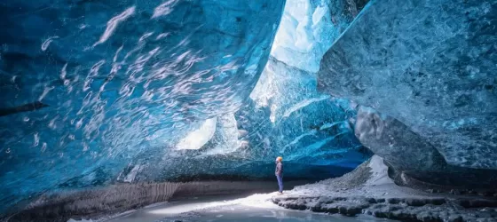 A man standing in Vatnajokull ice cave.