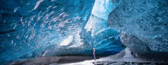 A man standing in Vatnajokull ice cave.