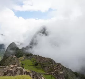Clouds hanging on to Huayna Picchu and slowly drifting off the Machu Picchu Mountain Ruins.