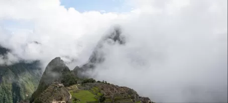 Clouds hanging on to Huayna Picchu and slowly drifting off the Machu Picchu Mountain Ruins.