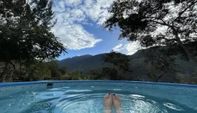 Enjoying a pisco, the jacuzzi, and the view at Lucma Lodge.