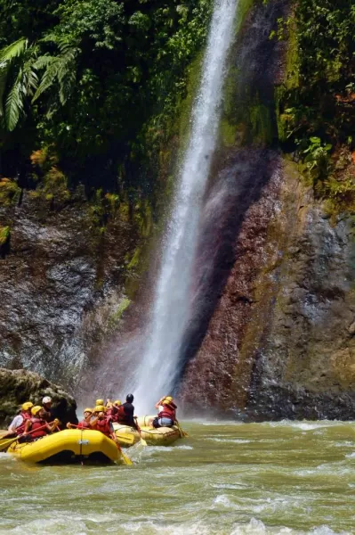 We are in the faded raft paddling upstream to the waterfall!