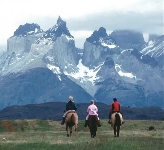 Horseback riding beneath Los Cuernos del Paine