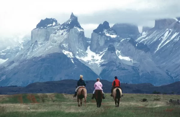 Horseback riding beneath Los Cuernos del Paine