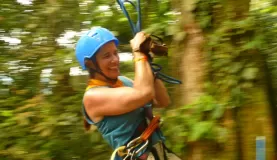 Pendulum swing through the rainforest during a zip line tour in Costa Rica