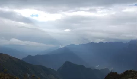 A lone sunbeam strikes the backside of Machu Picchu mountain