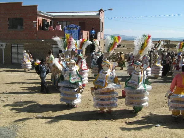 Street party with beautifully costumed dancers on the drive to La Paz