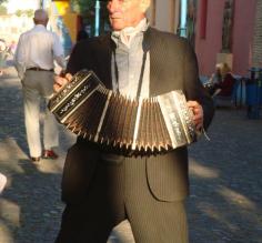 A man plays in the street
