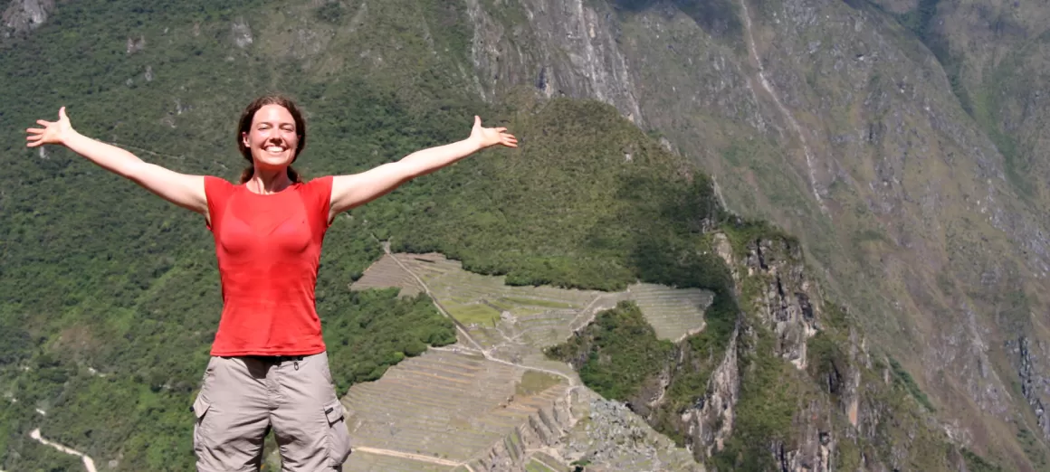 Take a victory picture from the top of Huayna Picchu on your Peru tour