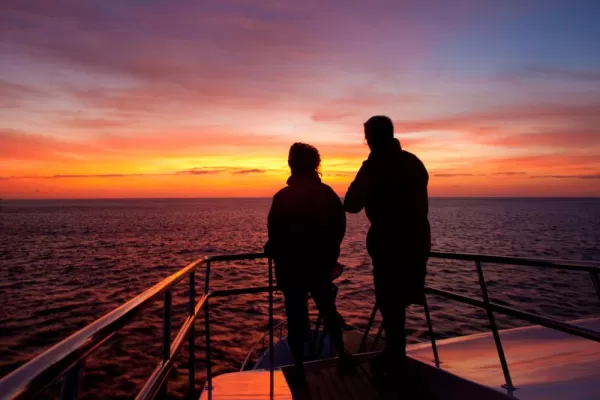 Watch the sun set over the warm Galapagos waters after a day of adventure