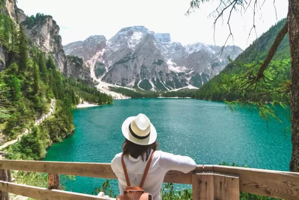 Traveler looking at the lake in Dolomites Alps