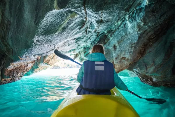 Woman paddles through the Marble Caves of Lake General Carrera, Aysen, Chile