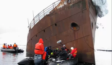 Camera crew next to the wreckage in Antarctica