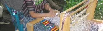 Watching a Maya woman weaving on Guatemala tour