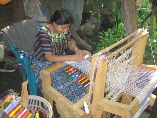 Watching a Maya woman weaving on Guatemala tour