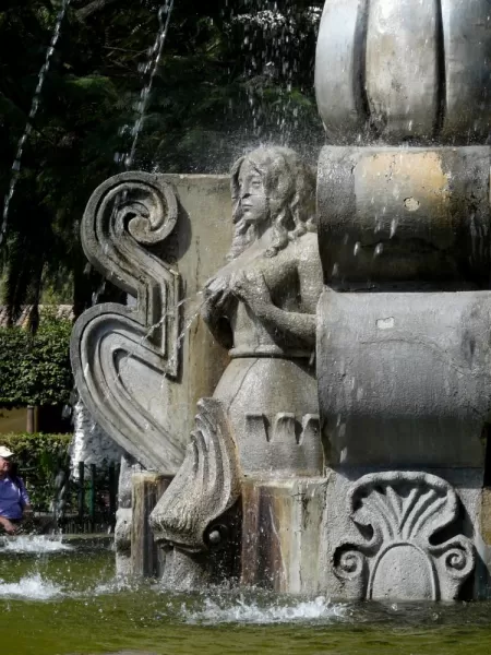 Unusual mermaids on fountain in center of park