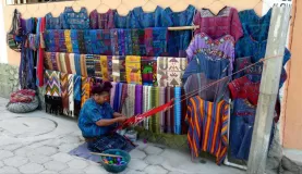 A local woman weaves beatiful textiles in Guatemala