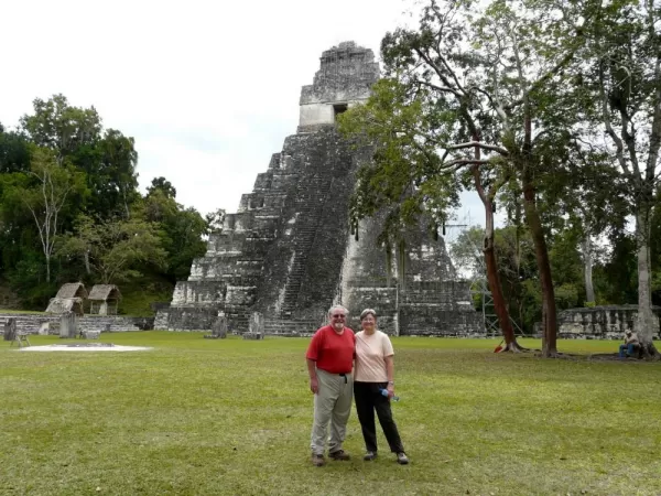 Posing for a picture in front of a temple in Tikal