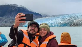 A couple snapping a selfie at Grey Glacier in Patagonia
