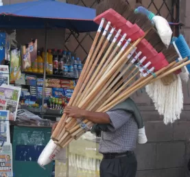 A street vendor peddles brooms in downtown Quito