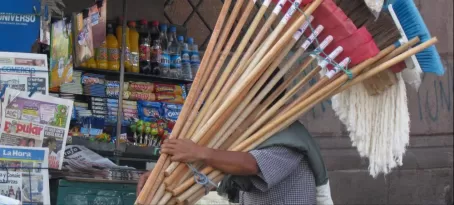 A street vendor peddles brooms in downtown Quito