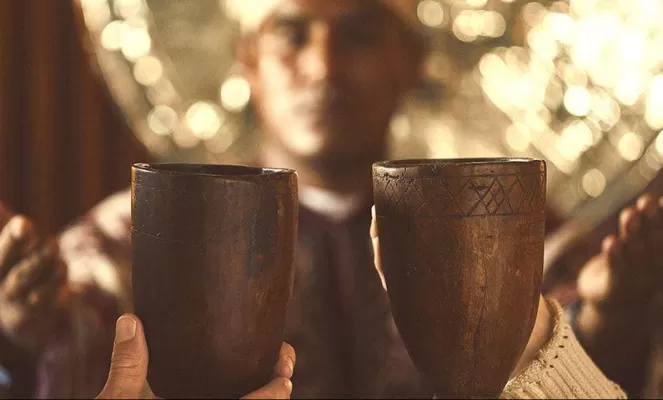 Close up of two cups made of wood held close at Hotel Sumaq