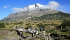 A trekking group crosses a creek in Torres del Paine 